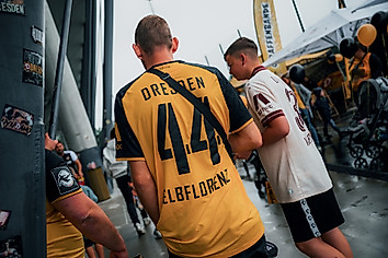 Zwei Dynamo-Fans in Trikots unter der Tribüne des Rudolf-Harbig-Stadions.