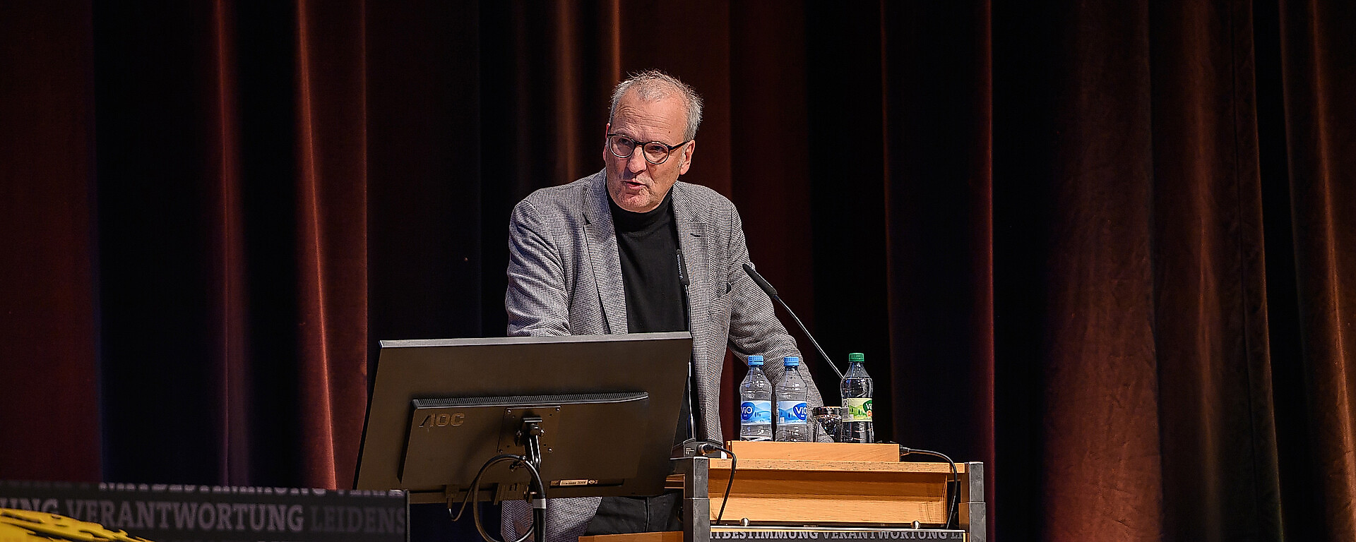 Dr. Jürg Kasper am Mikrofon bei der Mitgliederversammlung.
