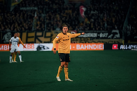 Aljaz Casar im gelben Dynamo-Trikot auf dem Spielfeld.