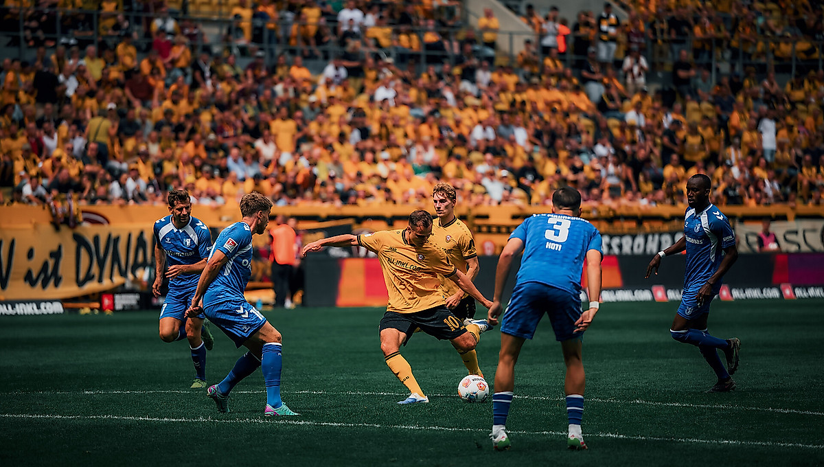Jakob Lemmer holt im Rudolf-Harbig-Stadion zum Schuss aus. Im Vordergrund sind vier Magdeburger Spieler zu sehen.