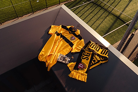 Ein Trikot, ein Schal und eine Postkarte aus der schwarzen Retrobox.