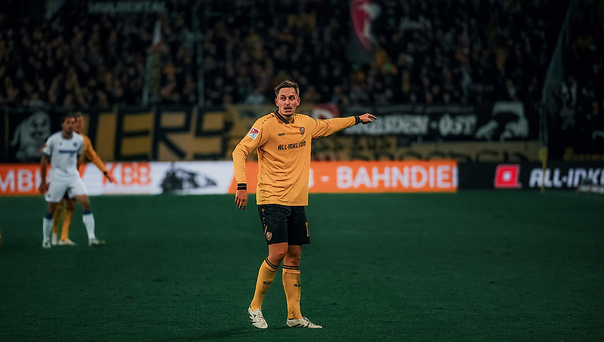 Aljaz Casar im gelben Dynamo-Trikot auf dem Spielfeld.