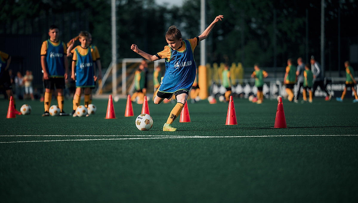 Ein Junge schießt den Ball auf ein Tor.