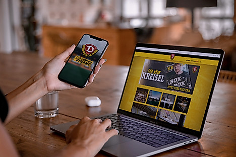 Ein Laptop und ein Handy, auf denen jeweils Dynamo-Seiten geöffnet sind