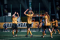 Die Spielerinnen der SGD klatschen auf dem Platz ab.