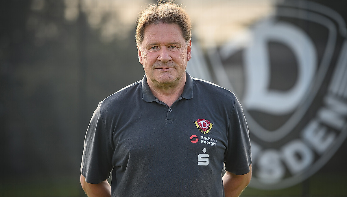 Ein Portrait von Andreas Trautmann vor dem Wappen der SGD.