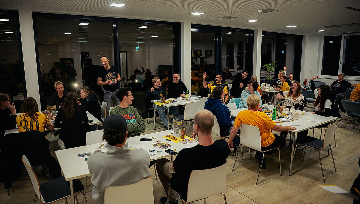 Eine Gruppe Menschen sitzt bei Brettspielen zusammen