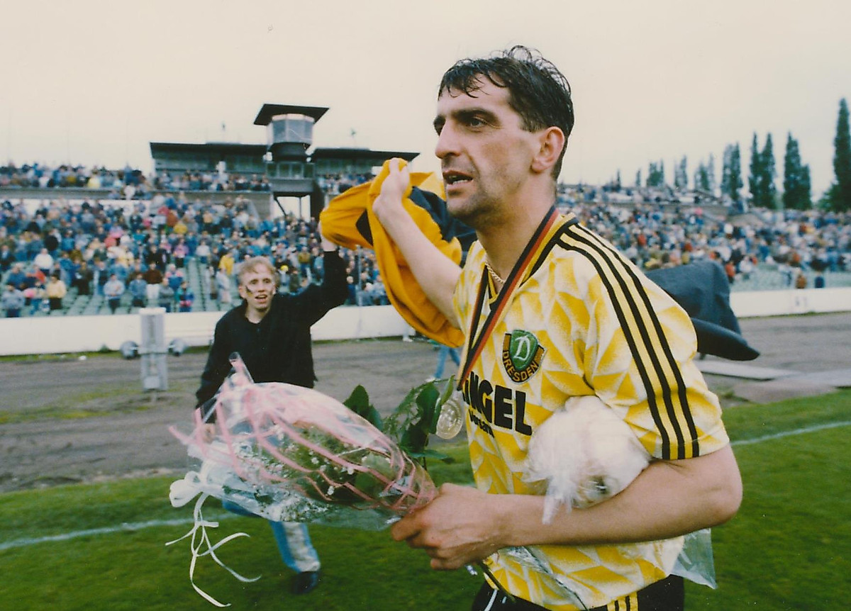 Ralf Minge mit einem Blumenstrauß in der Hand